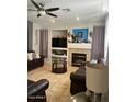Inviting living room with fireplace, tile flooring, and ample seating at 135 N 119Th Dr, Avondale, AZ 85323
