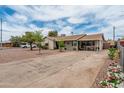 Charming single-story home with desert landscaping and a long driveway at 1934 W Colter St, Phoenix, AZ 85015