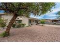 Inviting single-story home with desert landscaping and mature shade tree at 1934 W Colter St, Phoenix, AZ 85015