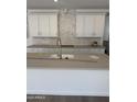 Close up view of kitchen island with sink and pull-down faucet at 2467 W Rowel Rd, Phoenix, AZ 85085
