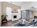 Bright living room with a white fireplace, vaulted ceilings, and wood-look tile flooring at 5726 N 10Th St # 5, Phoenix, AZ 85014