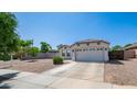 Charming single-story home with a well-maintained front yard, desert landscaping, and a two-car garage at 6092 S Bridal Vail Dr, Gilbert, AZ 85298