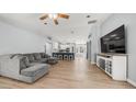 Open concept living room with vaulted ceiling, ceiling fan, and gray sectional sofa at 6092 S Bridal Vail Dr, Gilbert, AZ 85298