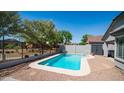 Backyard featuring a fenced swimming pool, with patio area and mature trees, perfect for outdoor entertainment at 6092 S Bridal Vail Dr, Gilbert, AZ 85298