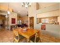Inviting dining area with a classic chandelier, open floor plan, and tile flooring at 1221 E Cholla St, Phoenix, AZ 85020