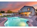 Stunning backyard featuring a covered patio, a built-in barbecue, and a private pool is perfect for entertaining at 18103 W Canyon Ln, Goodyear, AZ 85338