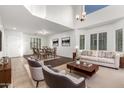 Bright living room features a soaring ceiling, lots of natural light, and neutral decor at 21672 N Geraldine Dr, Peoria, AZ 85382