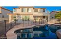 The home features a sparkling pool with a patio at 21672 N Geraldine Dr, Peoria, AZ 85382