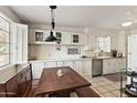 Bright kitchen featuring custom cabinets, a built-in dining nook, and a view to the neighborhood beyond at 2205 W Gardenia Dr, Phoenix, AZ 85021