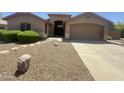 Attractive single-story home with well-maintained desert landscaping, two car garage and covered porch at 2453 E Nathan Way, Chandler, AZ 85225