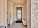 Elegant front door with decorative glass and a covered porch, complemented by stylish decor at 29363 N 132Nd Ln, Peoria, AZ 85383
