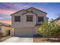Charming two-story home with a two car garage and neutral colored stucco in a residential neighborhood at 567 E Bradstock Way, Queen Creek, AZ 85140