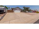 Spacious driveway leading to a two-car garage, plus secure RV parking with private gated fence at 6110 E Ivyglen St, Mesa, AZ 85205