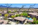 Community aerial view featuring a pool and spa, covered parking, and desert surroundings at 20100 N 78Th Pl # 2105, Scottsdale, AZ 85255