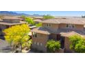 Inviting multi-level condo featuring a landscaped front, covered balcony, and desert surroundings at 20100 N 78Th Pl # 2105, Scottsdale, AZ 85255