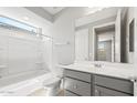 Bathroom featuring a tub-shower combination, sleek vanity, and neutral wall color at 26992 W Melinda Ln, Buckeye, AZ 85396