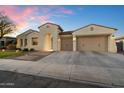 Beautiful home exterior showcasing a brick-accented driveway, a two-car garage, and manicured landscaping at dusk at 3574 E Tonto Pl, Chandler, AZ 85249