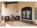 Inviting front porch with seating area and a decorative double door entrance at 36075 N Summit Dr, Cave Creek, AZ 85331
