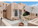 A charming patio with seating and a table under a large umbrella, offering a delightful outdoor living space at 5756 N 78Th Pl, Scottsdale, AZ 85250