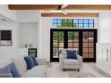 Cozy living room featuring a wet bar, black framed windows, beamed ceilings and stylish furniture at 5756 N 78Th Pl, Scottsdale, AZ 85250