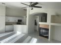 Spacious living room featuring an open floor plan, fireplace, white walls, and tile floors at 8009 S 53Rd Ave, Laveen, AZ 85339