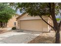 Beige home with a large two-car garage and low-maintenance desert landscaping at 10317 E Kiva Cir, Mesa, AZ 85209