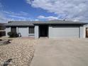 Charming single-story home with gray paint, low-maintenance landscaping, and an attached two-car garage at 10852 N 39Th Ave, Phoenix, AZ 85029