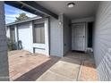 Covered front porch entry with decorative security door and painted brick detail at 10852 N 39Th Ave, Phoenix, AZ 85029