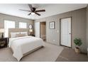 Cozy bedroom features a comfortable bed, soft carpet, and an ensuite bathroom for added convenience at 10951 N 91St Ave # 6, Peoria, AZ 85345