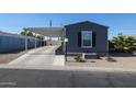 Exterior of home featuring covered parking, landscaped yard, and gray siding at 10951 N 91St Ave # 6, Peoria, AZ 85345
