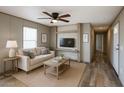 Inviting living room with a ceiling fan, comfortable seating, and an entertainment center with a mounted television at 10951 N 91St Ave # 6, Peoria, AZ 85345