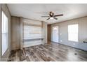 Living room featuring vinyl floors and custom entertainment center at 10951 N 91St Ave # 6, Peoria, AZ 85345