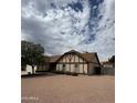 Charming single-Gathering home featuring a Tudor-style facade and low-maintenance desert landscaping in the front yard at 12512 N 85Th Ave, Peoria, AZ 85381