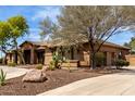 Well-maintained home showcasing desert landscaping and a circular driveway at 14188 W Hope Dr, Surprise, AZ 85379