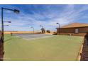 Private tennis court with professional surfacing and lighting, perfect for recreational play at 14188 W Hope Dr, Surprise, AZ 85379