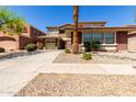 Charming two-story home with a two-car garage, desert landscaping and a well-manicured lawn at 16022 W Desert Mirage Dr, Surprise, AZ 85379