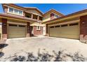 Large three-car garage with brick accents and a desert-style front yard, offering ample parking space at 16022 W Desert Mirage Dr, Surprise, AZ 85379