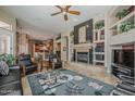 Inviting living room showcasing a cozy fireplace, custom built-ins, and an open floor plan at 16441 S Mountain Stone Trl, Phoenix, AZ 85048