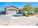Beautiful home featuring a three-car garage and a cozy front patio, perfect for enjoying the outdoors at 17054 W Saguaro Park Ln, Surprise, AZ 85387