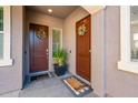 Two front doors with decorative wreaths, creating a warm welcome and an inviting entryway at 17054 W Saguaro Park Ln, Surprise, AZ 85387