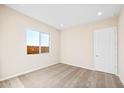 Well-lit bedroom featuring neutral walls, carpet, and a window offering natural light at 18840 N 269Th Ave, Buckeye, AZ 85396