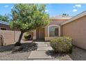Inviting front entrance with desert landscaping and stepping stone walkway at 20501 N 93Rd Ave, Peoria, AZ 85382