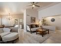 Comfortable living room with vaulted ceiling, plush seating and modern decor at 20501 N 93Rd Ave, Peoria, AZ 85382