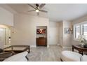 Bright and airy living room with wood-look flooring, a ceiling fan and neutral decor at 20501 N 93Rd Ave, Peoria, AZ 85382