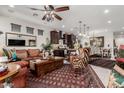 Open concept living space featuring modern decor, a large area rug, comfortable seating, and seamless access to kitchen and dining areas at 20839 E Kingbird Dr, Queen Creek, AZ 85142