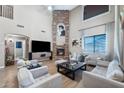 Spacious living room with a stone fireplace and comfortable seating arrangement, perfect for entertaining at 21147 E Via Del Oro --, Queen Creek, AZ 85142