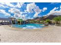 Relaxing community pool featuring plenty of seating, splash pad and mountain views at 21412 W Hubbell St, Buckeye, AZ 85396