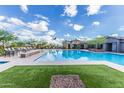 Gorgeous community pool with splash pad, lounge chairs and shaded picnic areas at 21412 W Hubbell St, Buckeye, AZ 85396