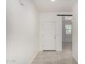 Bright hallway boasts neutral tile flooring leading to the main living areas at 21412 W Hubbell St, Buckeye, AZ 85396