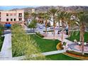 Picturesque community green space with palm trees, seating areas, and scenic views of the surrounding area at 21564 W Pierson St, Buckeye, AZ 85396